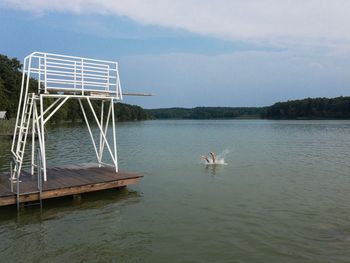 Scenic view of diving platform in lake against sky