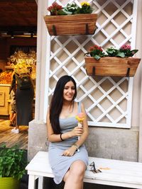 Portrait of young woman sitting outdoors