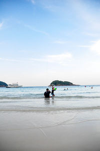 Man on beach against sky