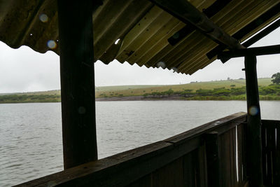 Pier over river against sky