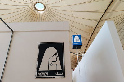 Low angle view of female sign in public restroom