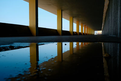 Reflection of building in puddle