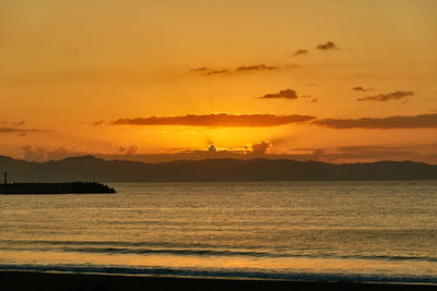 Scenic view of sea against romantic sky at sunset