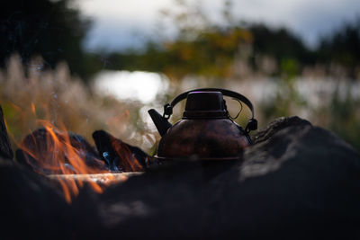 Close-up of teapot on fire