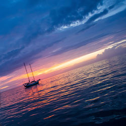 Boat in sea at sunset