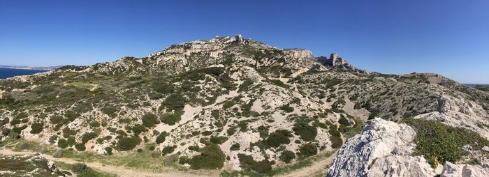 Scenic view of mountains against clear blue sky