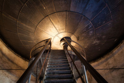 Rear view of man on staircase in tunnel