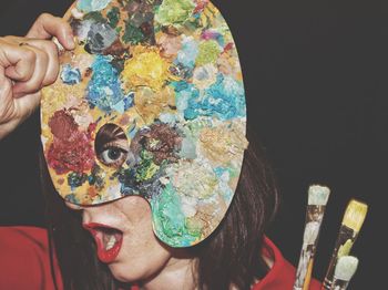 Portrait of man holding multi colored painting