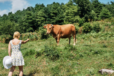 Full length of woman standing on field