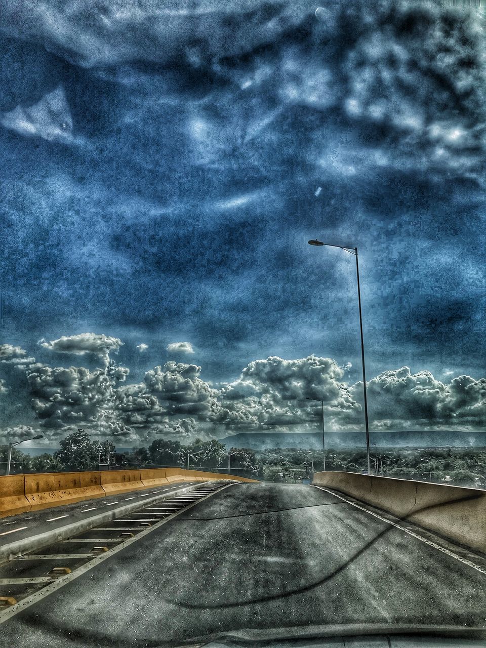 ROAD AGAINST STORM CLOUDS