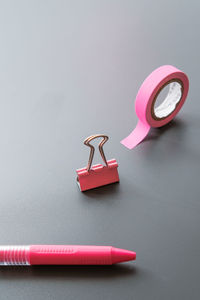 Close-up of pink equipment on table against gray background