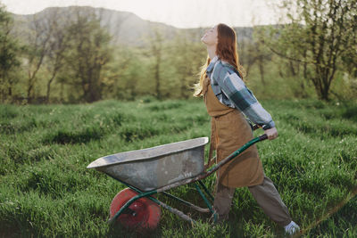 Rear view of woman standing on field