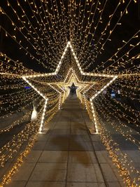 Illuminated lights on footpath at night