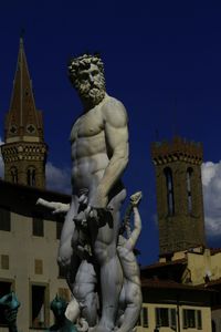 Low angle view of statue against blue sky