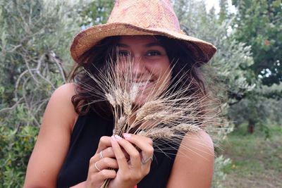 Midsection of woman holding hat