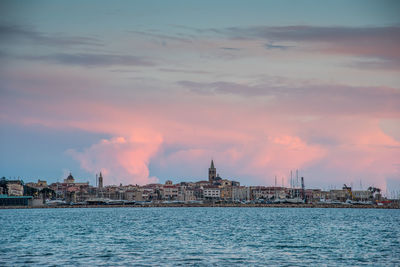 View of buildings in city at sunset