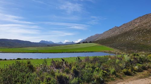 Scenic view of lake and mountains against sky