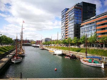 Boats in river with buildings in background