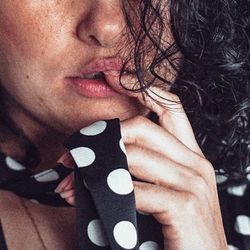 Close-up portrait of woman with hands