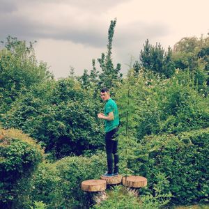 Full length of child on tree against sky