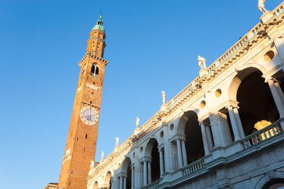 Low angle view of historical building against blue sky