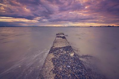 Scenic view of sea against cloudy sky