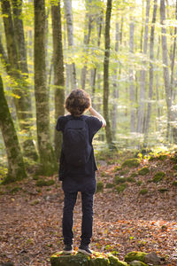 Rear view of man standing in forest