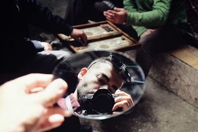 High angle view of people holding hands on table