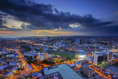 High angle view of illuminated buildings against sky at sunset