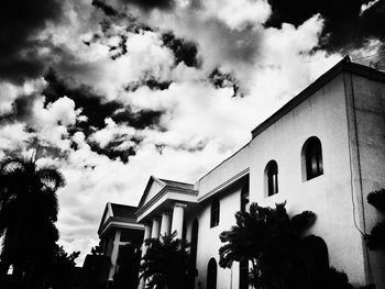 Low angle view of building against cloudy sky