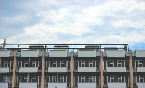 Low angle view of building against cloudy sky