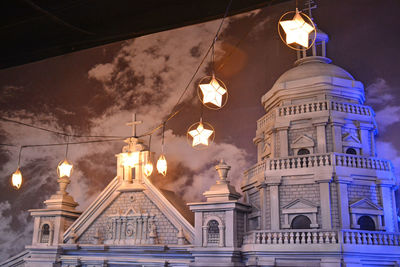 Low angle view of illuminated building against sky