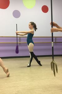 Rear view of woman with umbrella standing on floor