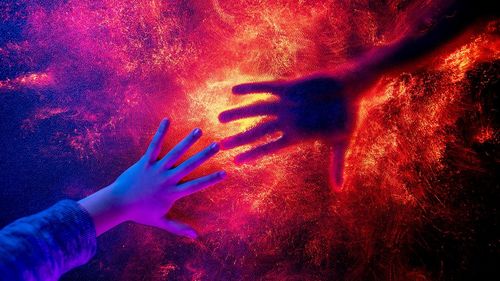 Midsection of man touching illuminated light painting at night