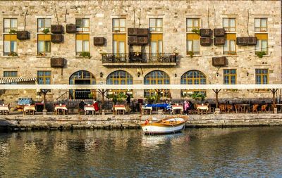 Boats in canal along buildings