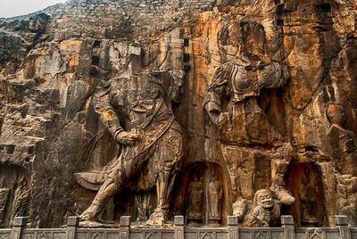 Low angle view of sculpture on rock