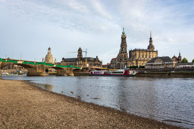 River amidst buildings against sky