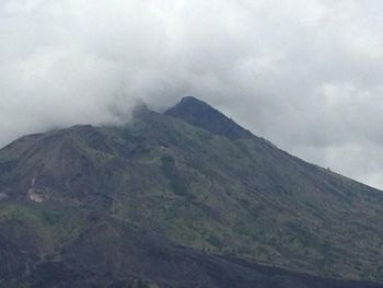 Scenic view of mountains against cloudy sky