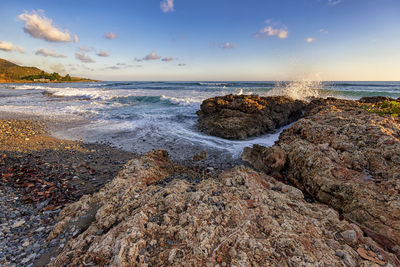 Amazing coast view near santiago de cuba. splash of seawater at rocks on the shore. 