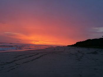 Scenic view of beach against sky during sunset