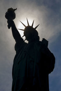 Low angle view of statue against cloudy sky