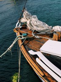 High angle view of fishing boat sailing in sea, wooden deck, ropes, accessories, sunny day 