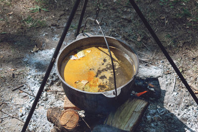 Hiking pot, bowler in the bonfire. fish soup boils in cauldron at the stake