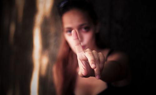 Close-up of young woman pointing