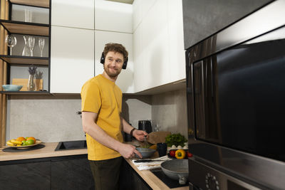 Young man preparing food at home