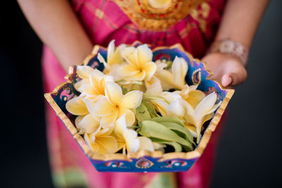 Close-up of woman holding flower