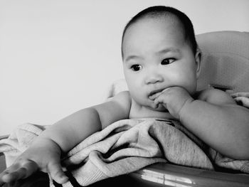 Cute baby sitting in carriage at home