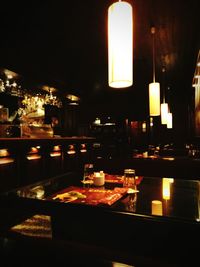 Close-up of illuminated bottles on table in restaurant