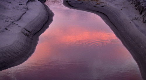 Rock formations against sky during sunset