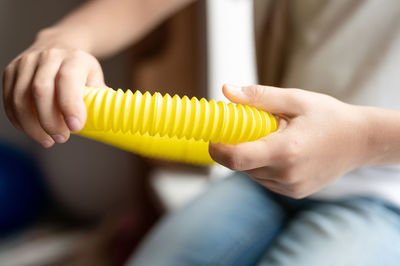 Anti stress sensory pop tube toys in a children's hands. a little kids plays with a poptube toy